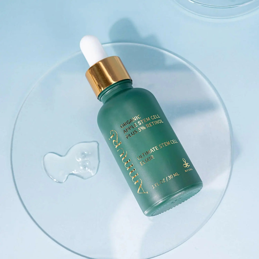 Ammuri Apple Stem Cell Retinol Serum 5% in green glass bottle with dropper on a reflective surface