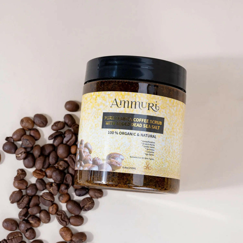 Ammuri Skincare Organic Arabica Coffee Scrub for Skin with Dead Sea Salt in a jar surrounded by coffee beans