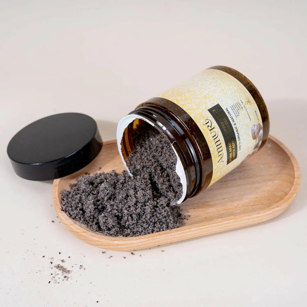 Ammuri Skincare Organic Coffee Scrub for Skin in jar with wooden plate and lid, highlighting natural exfoliation