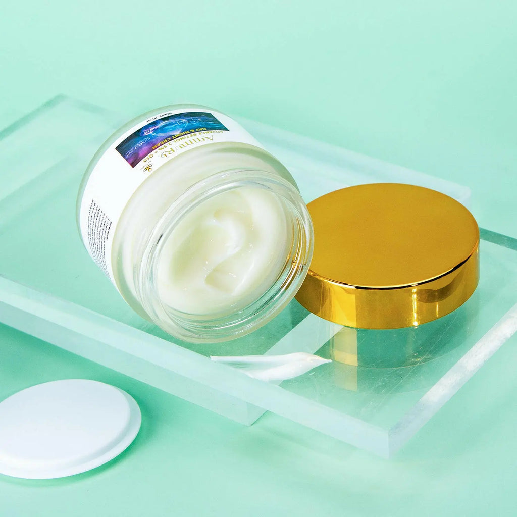 Ammuri Beauty Q10 face cream in a glass jar with a gold lid on a mint green background