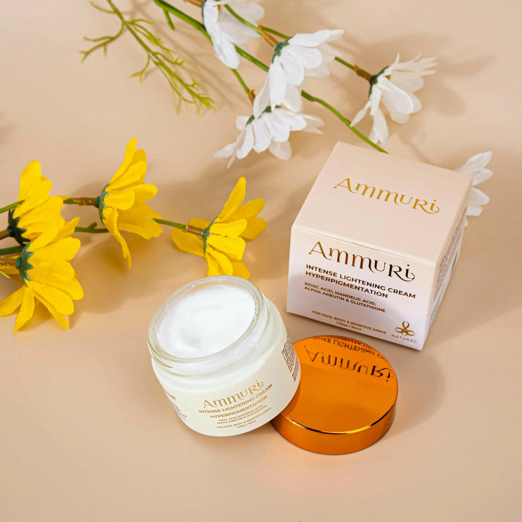 Ammuri Beauty skin lightening cream for dark spots in jar with flowers and packaging in the background