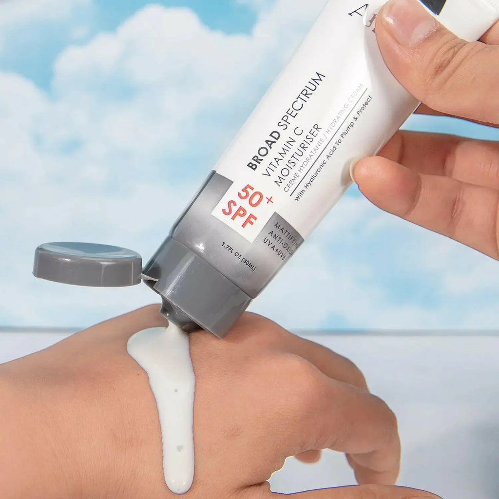 Ammuri Vitamin C Moisturizer SPF 50 being applied to skin, featuring a smooth, creamy texture