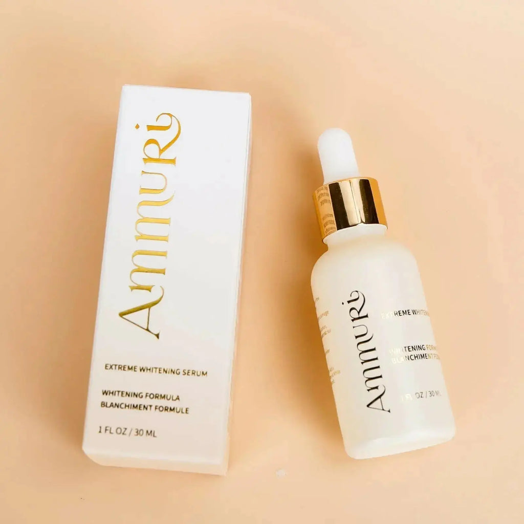 Ammuri whitening and brightening cream in a glass bottle with dropper beside its elegant white packaging