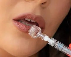 Ammuri Beauty microneedling serum roller being applied to enhance skin texture and reduce aging signs